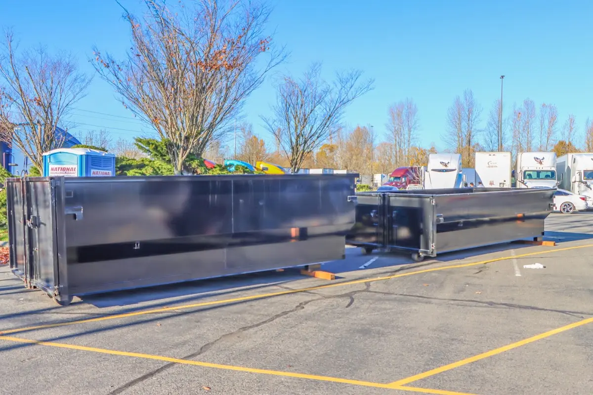 Professional dumpster rental service with roll-off container on residential driveway in Shirley